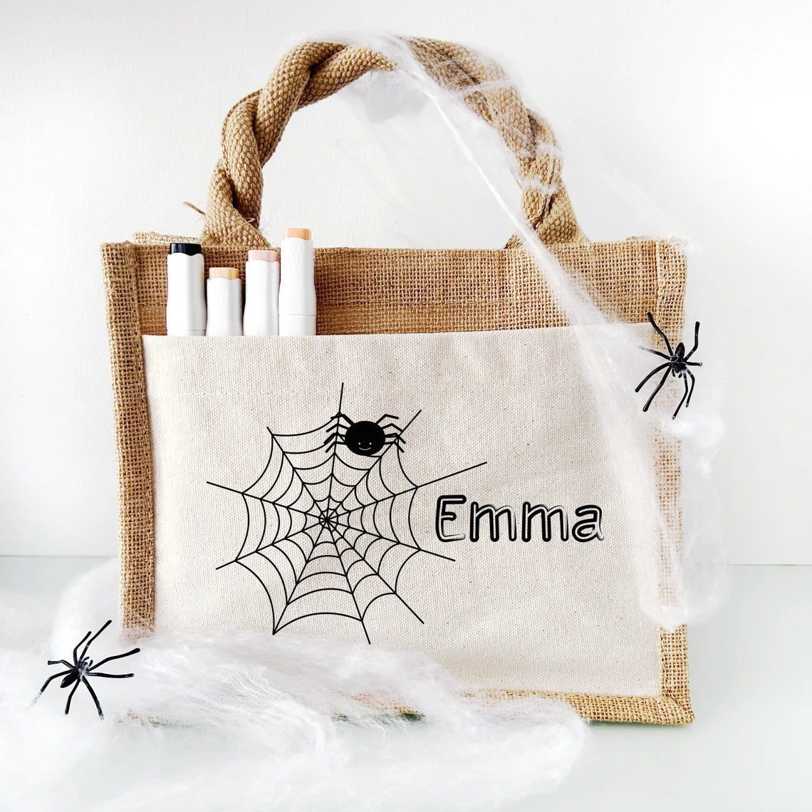 Jutetasche mit Spinnennetz, Spinne und dem Namen Emma, dekoriert mit Spinnweben und Stiften